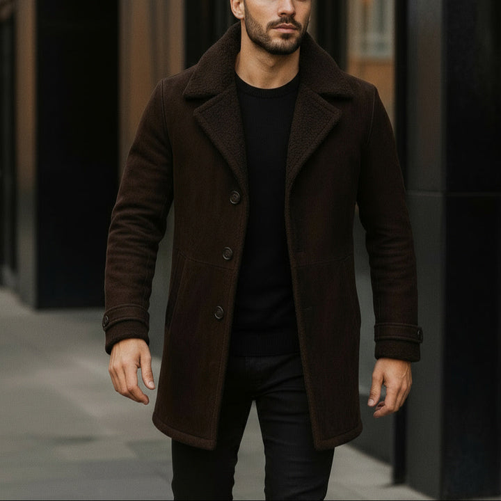 Man wearing a brown coat walking on a street.