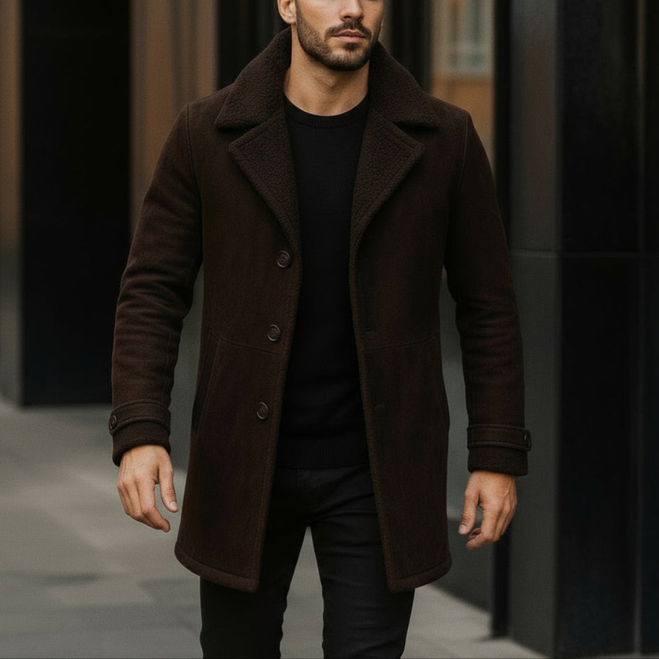 Man wearing a brown coat walking on a street.