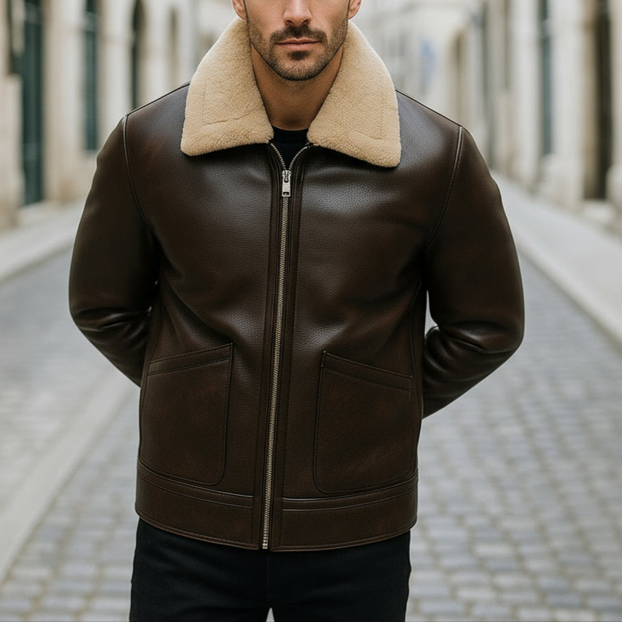 Man wearing a brown leather jacket with a beige fur collar on a city street.