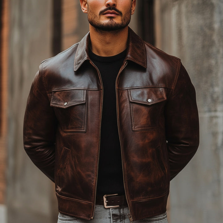 Man wearing a brown leather jacket with a blurred background