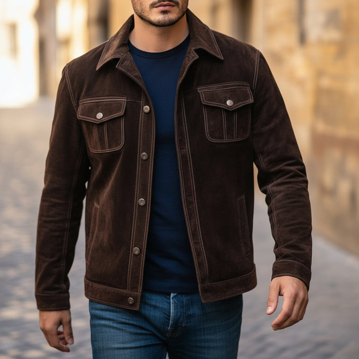 Man wearing a brown suede jacket with a blurred background