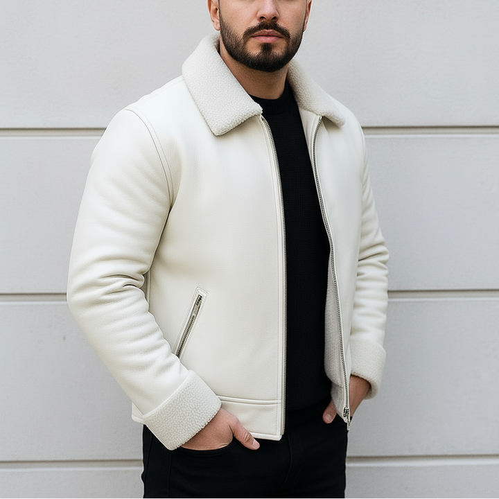 Man wearing a white jacket against a light-colored wall
