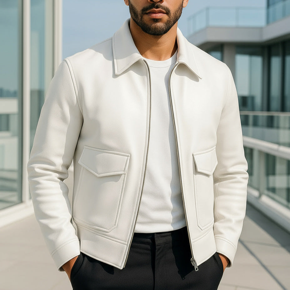 Man wearing a white jacket with a modern building in the background