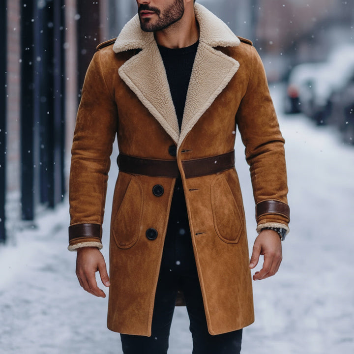 Man wearing a brown suede coat with a fur-lined hood in a snowy street.