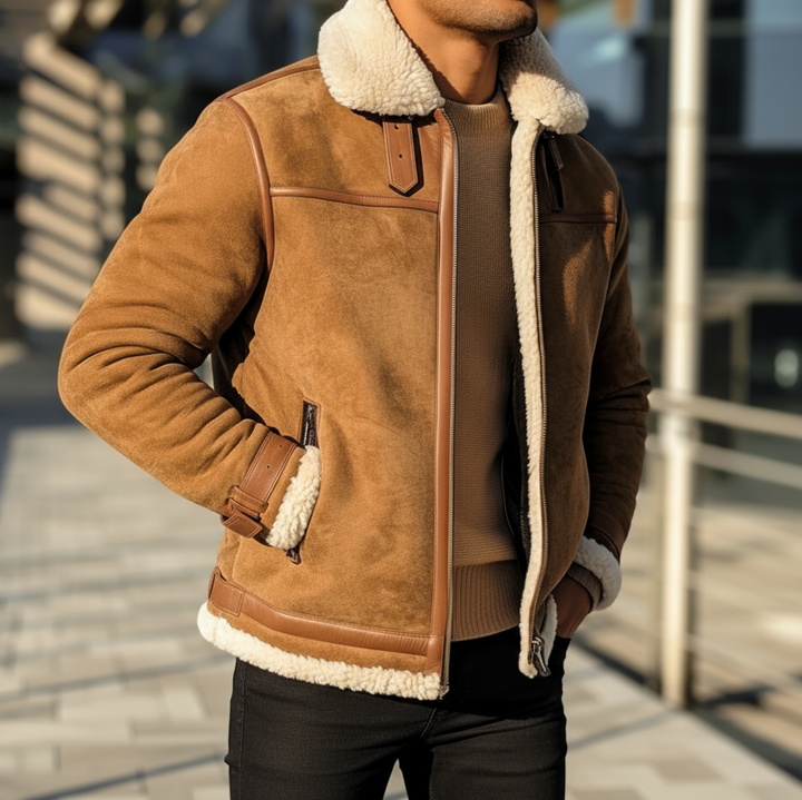 Person wearing a brown shearling jacket with white fur lining on a blurred street background